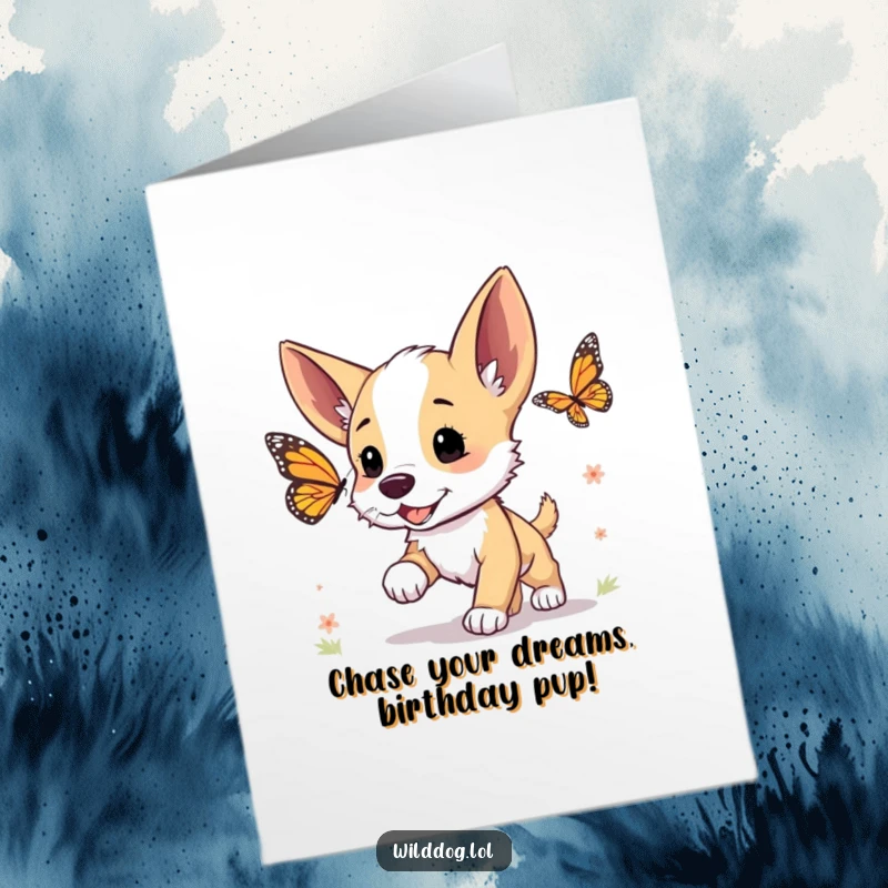 Funny Free Printable Birthday Card: A cute wild dog puppy with perked ears excitedly chases a colorful butterfly through a sunny meadow.
