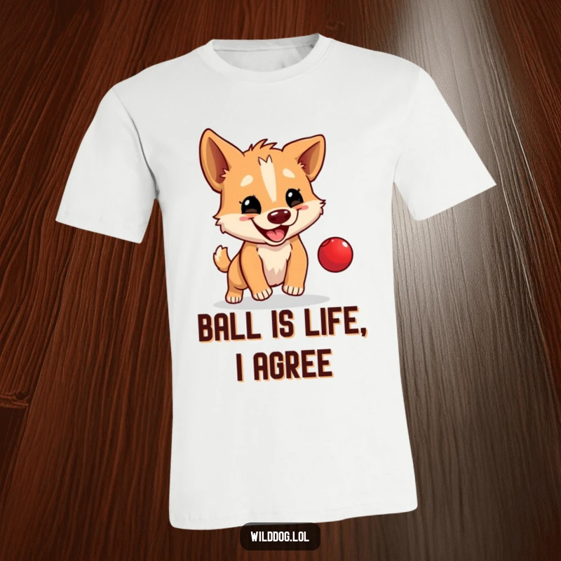 Funny t-shirt featuring a wild dog happily bouncing a tiny red ball, a playful and humorous apparel item.